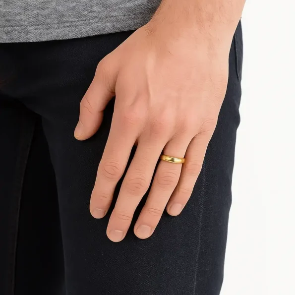 Men's gold wedding ring on finger styled with casual attire for daily wear
