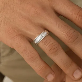 Men's white gold diamond wedding band worn on finger – elegant and modern look