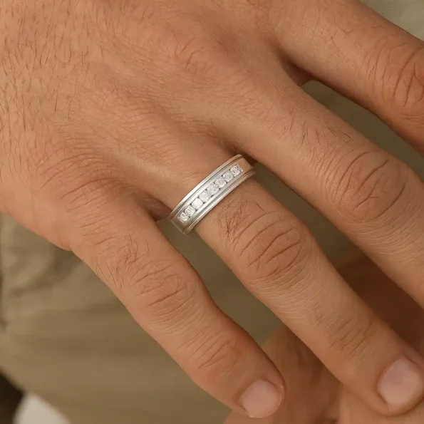 Men's white gold diamond wedding band worn on finger – elegant and modern look