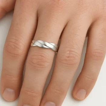 Twisted white gold men’s wedding ring worn on hand – modern and stylish crossover band for everyday wear or special occasions