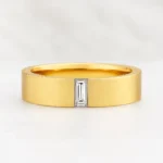 14K yellow gold men's wedding band with white baguette-cut gemstone set in center - front view