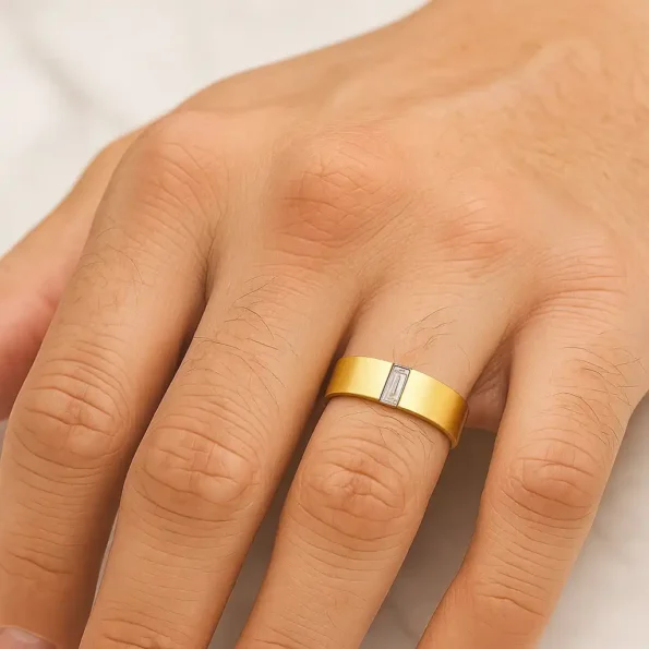 Men wearing 14K yellow gold wedding band featuring white baguette-cut gemstone - lifestyle view