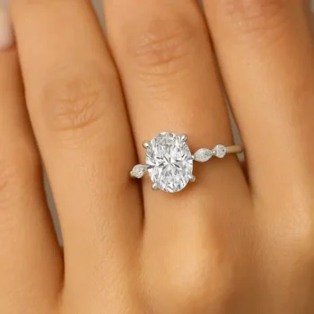Oval cut lab-grown diamond ring in white gold shown on hand for scale and sparkle effect