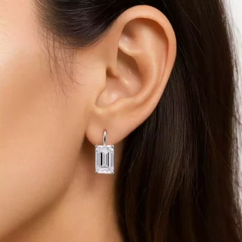 Model wearing emerald cut lab diamond drop earring in white gold showcasing elegant sparkle