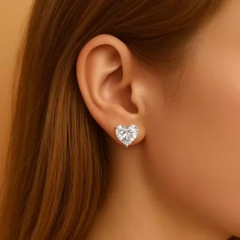 Model wearing heart-shaped lab diamond earrings in white gold for elegant everyday look