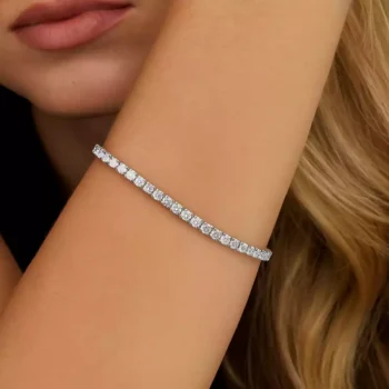 White gold round diamond tennis bracelet on woman's wrist – minimalist luxury jewelry for formal and casual wear