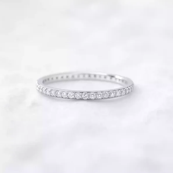 Thin white gold diamond band with lab-grown round stones – classic eternity wedding ring.