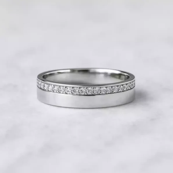 Brushed white gold diamond band ring featuring a horizontal row of round lab-grown diamonds in modern flat design