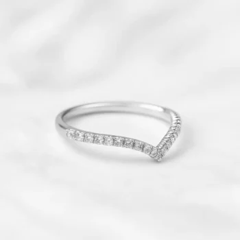 White gold V-shaped diamond band ring with pave setting on white background