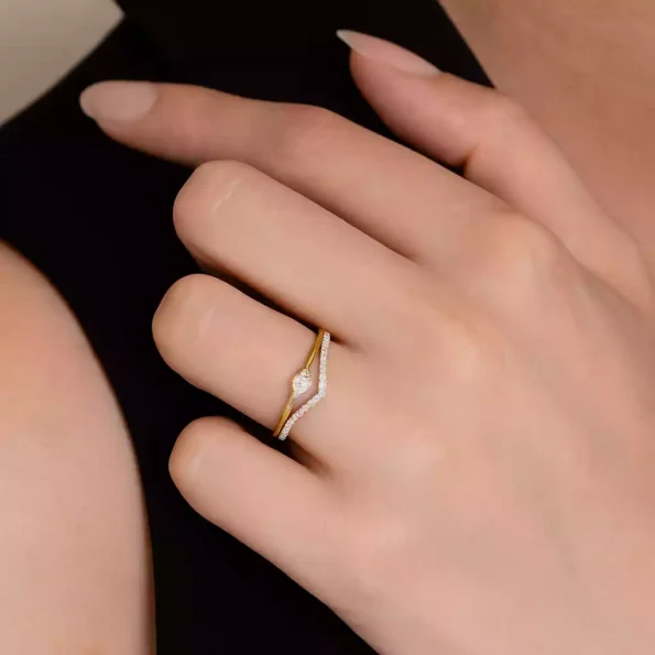 Stacked V-shaped gold diamond band ring worn on woman's hand for elegant bridal look