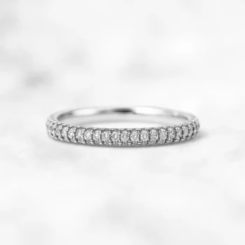 Pave set lab grown diamond eternity wedding band in white gold on white background