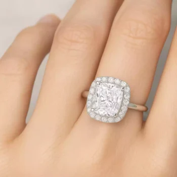 cushion cut lab diamond halo engagement ring on woman's hand – white gold vintage-inspired style