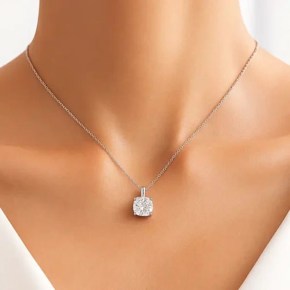 Elegant cushion cut lab diamond necklace in white gold worn on female model's neckline