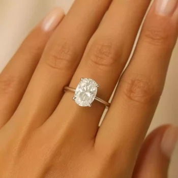 elongated cushion lab diamond engagement ring on woman's hand – classic white gold solitaire design