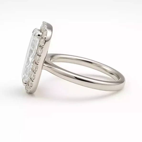 Side profile of elongated cushion cut lab diamond halo ring in white gold with slim band and raised setting