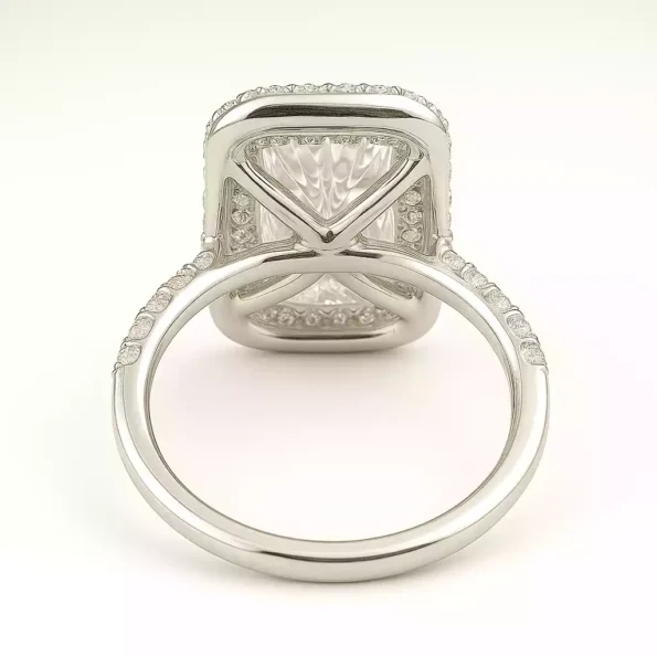 Underside of elongated cushion halo lab diamond engagement ring with cathedral setting in white gold