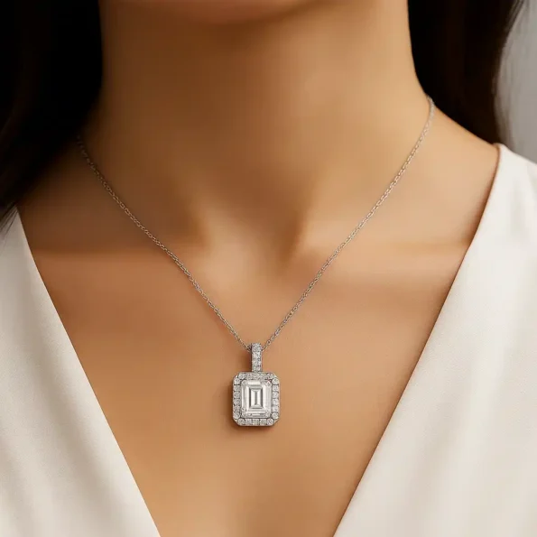 Woman wearing emerald cut lab diamond halo pendant in white gold with prong setting – lifestyle close-up
