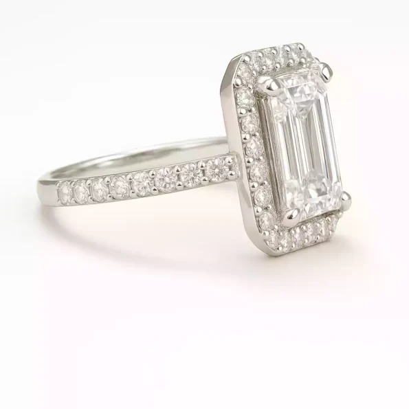 Elegant side profile of emerald cut lab diamond ring with pavé band and halo