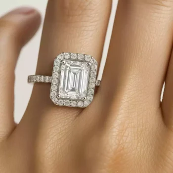 Emerald cut halo diamond engagement ring on woman's hand showcasing sparkle and size