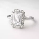 Emerald cut lab-grown diamond halo engagement ring in white gold – front angle with pavé setting