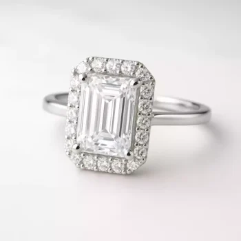 Emerald cut lab-grown diamond halo engagement ring in white gold – front angle with pavé setting
