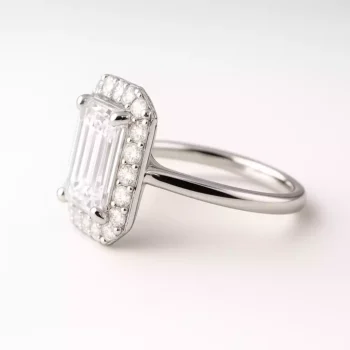 Side profile of emerald cut lab-grown diamond ring in white gold – raised basket and slim band
