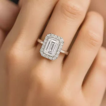 Emerald cut halo diamond engagement ring on woman's hand – lab-created diamond in white gold setting
