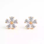 Flower-shaped diamond stud earrings with pear-cut diamonds in rose gold setting – front view