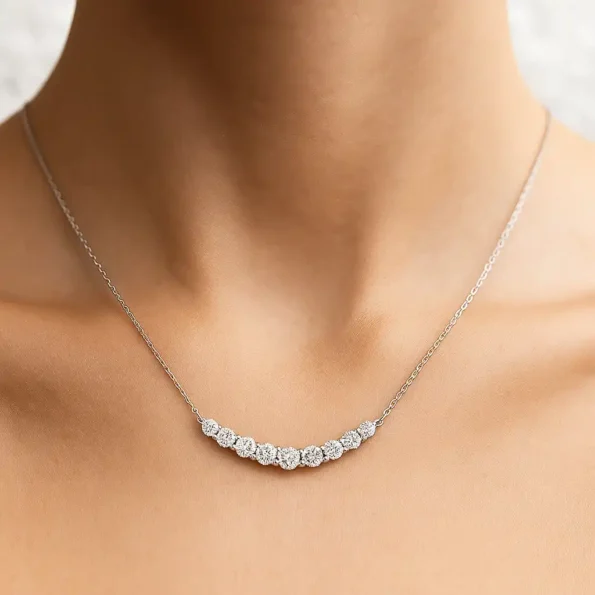 Neckline view showcasing curved bar necklace with sparkling round lab diamonds in white gold