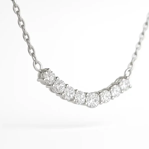 Close-up side angle of prong-set round lab-grown diamonds in a curved journey pendant necklace