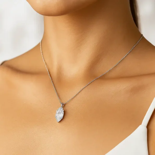 Elegant marquise diamond pendant necklace worn by woman on neckline