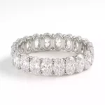 Side angled view of full eternity ring with oval cut lab diamonds set in prong style white gold