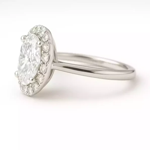 Side profile of oval cut halo engagement ring with lab diamond and petite white gold band