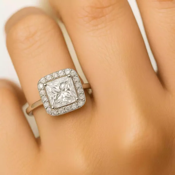 Princess cut halo diamond ring on finger showing brilliance and dimension.