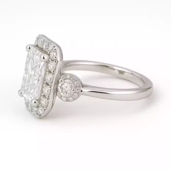 Left side profile of radiant cut lab-created diamond ring with halo and side stones in white gold