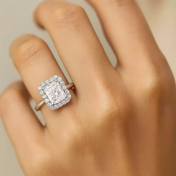 Radiant cut halo diamond engagement ring on finger for scale and fit