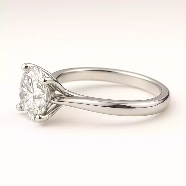 Side profile of round cut solitaire lab diamond ring in sleek white gold band