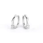 Close-up view of round solitaire diamond hoop earrings in white gold with prong setting