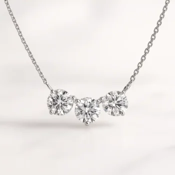 Three stone round cut lab-grown diamond necklace in white gold setting on delicate chain - front view