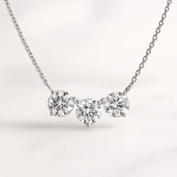 Three stone round cut lab-grown diamond necklace in white gold setting on delicate chain - front view