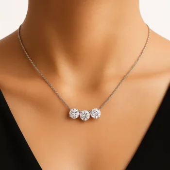 Elegant three stone lab diamond necklace in white gold worn on neckline - lifestyle view
