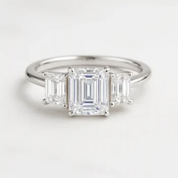 Emerald cut three-stone lab-grown diamond engagement ring in white gold with step-cut side stones
