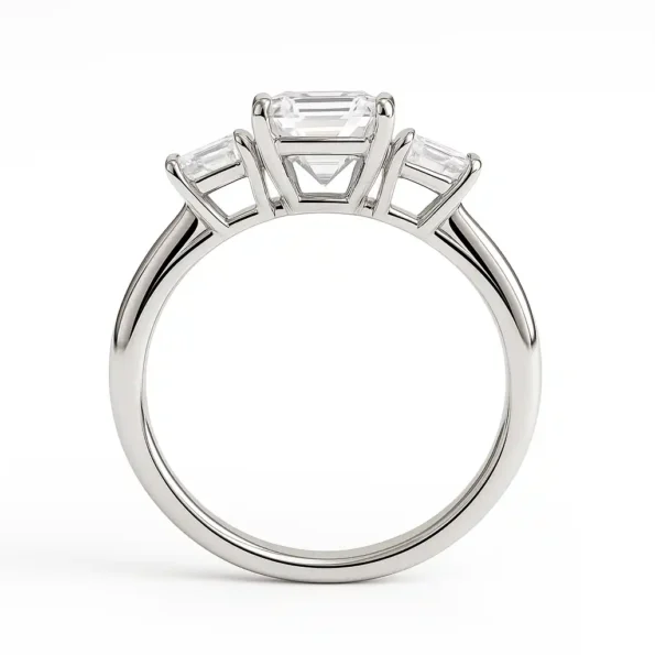 Close-up of prong setting in three-stone emerald cut diamond engagement ring in 18K white gold