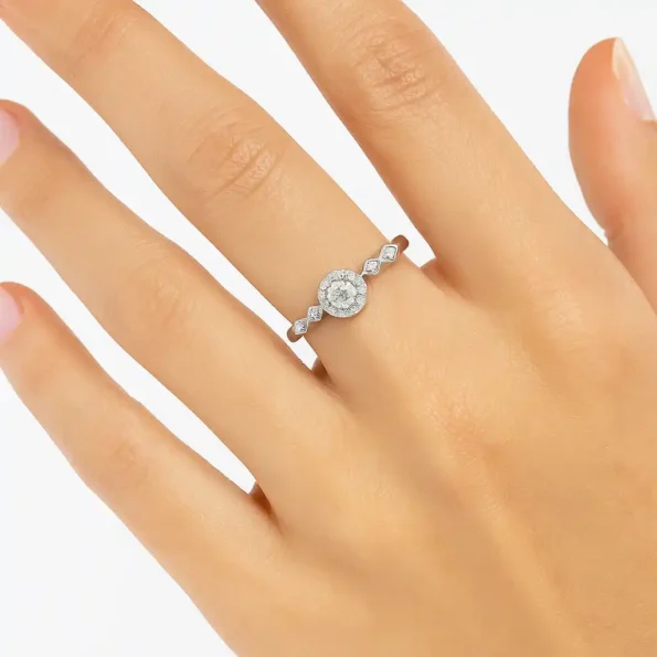 Round halo diamond ring with marquise and princess accents on woman's hand