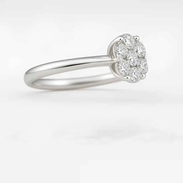 Side view of white gold round diamond cluster ring with prong setting and sleek band