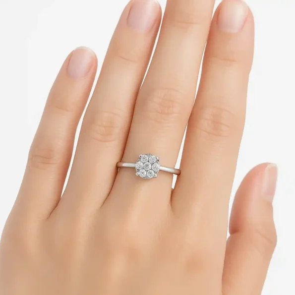 7-stone round diamond cluster engagement ring in white gold shown on hand for size reference