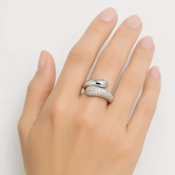 White gold bypass diamond ring worn on woman's hand – elegant and modern design