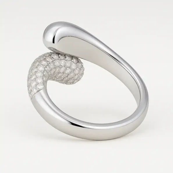 Curved bypass diamond ring in white gold with high polish and pavé diamonds – side angle