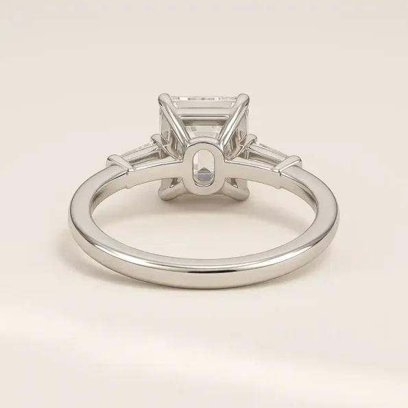 Back angle of white gold emerald cut lab-grown diamond ring with tapered baguette side stones