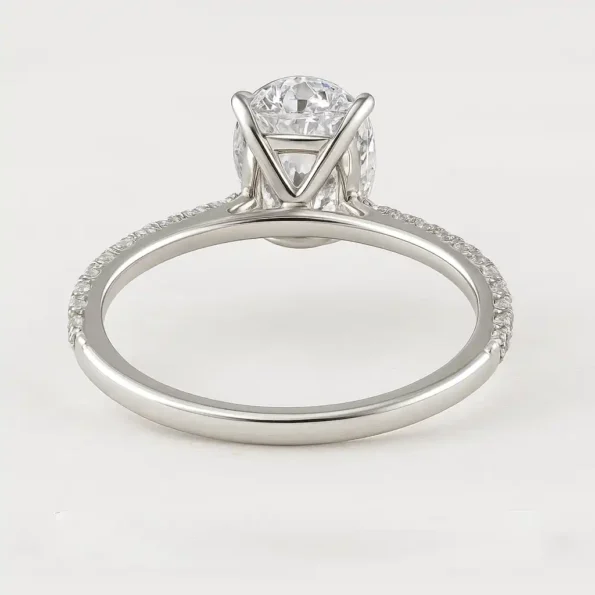 White gold engagement ring with oval center diamond and pavé band - back view of setting